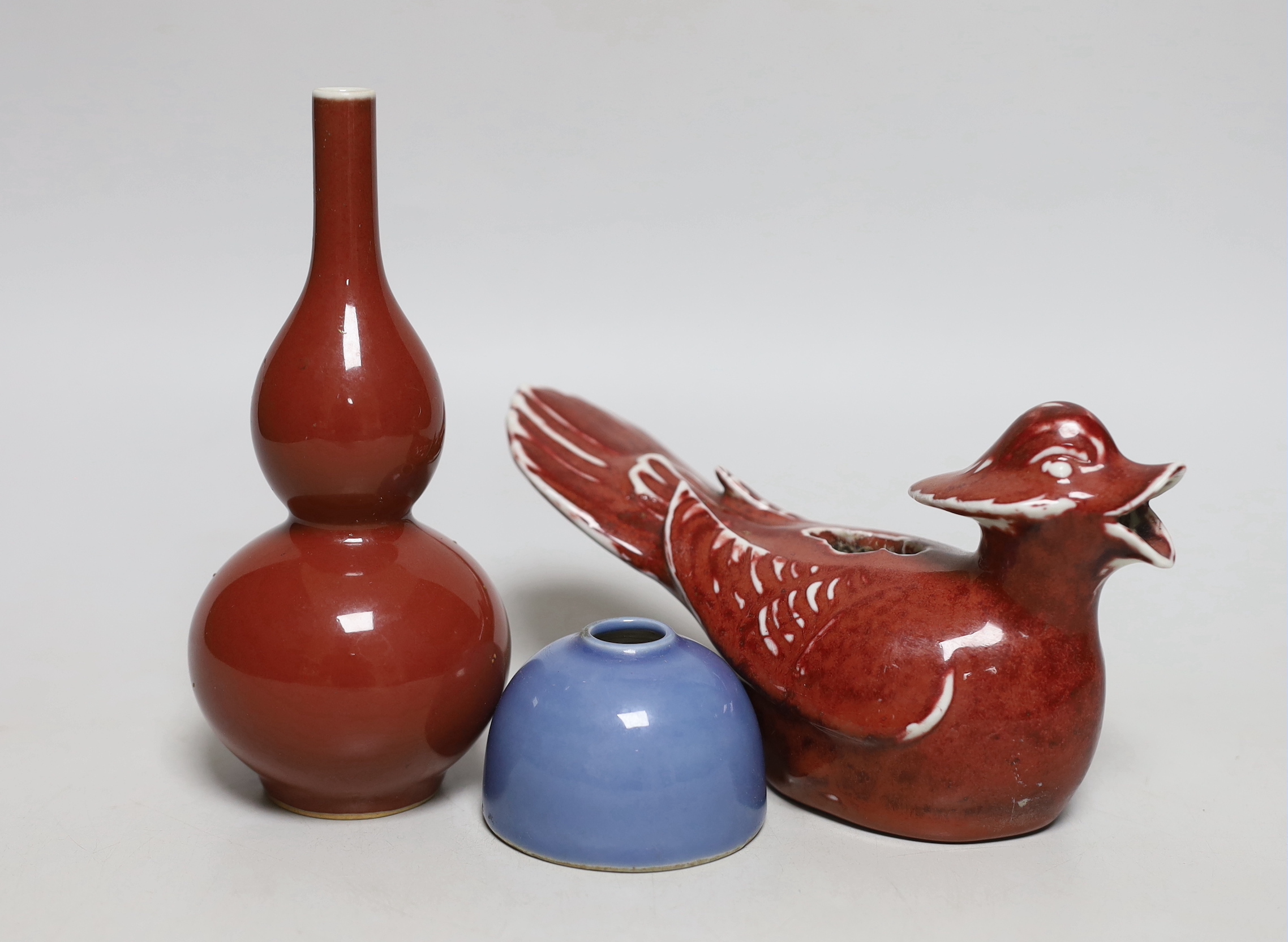 A small Chinese sang de boeuf glazed double gourd vase, 17cm high, and a Chinese sang de boeuf cockerel and blue glazed inkwell, cockerel 18cm wide